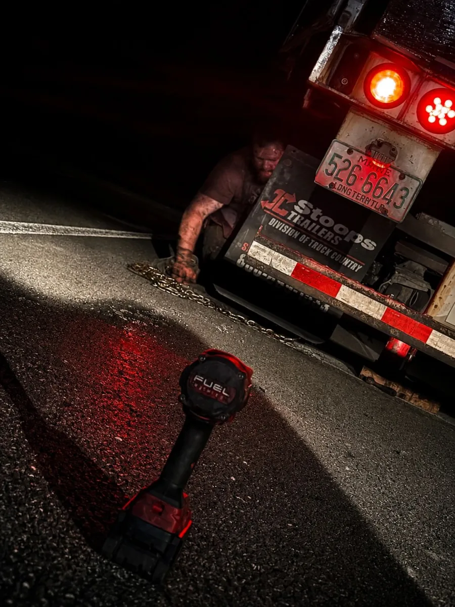 Trailer on the roadside at night under work lights